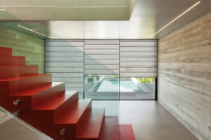 Interior, red staircase in modern villa
