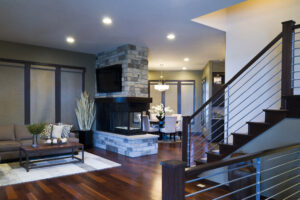 Expansive and modern living room seperated from the dining room by a fireplace