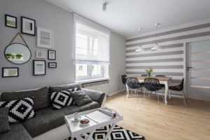 Home interior with modern gray sofa and dining table